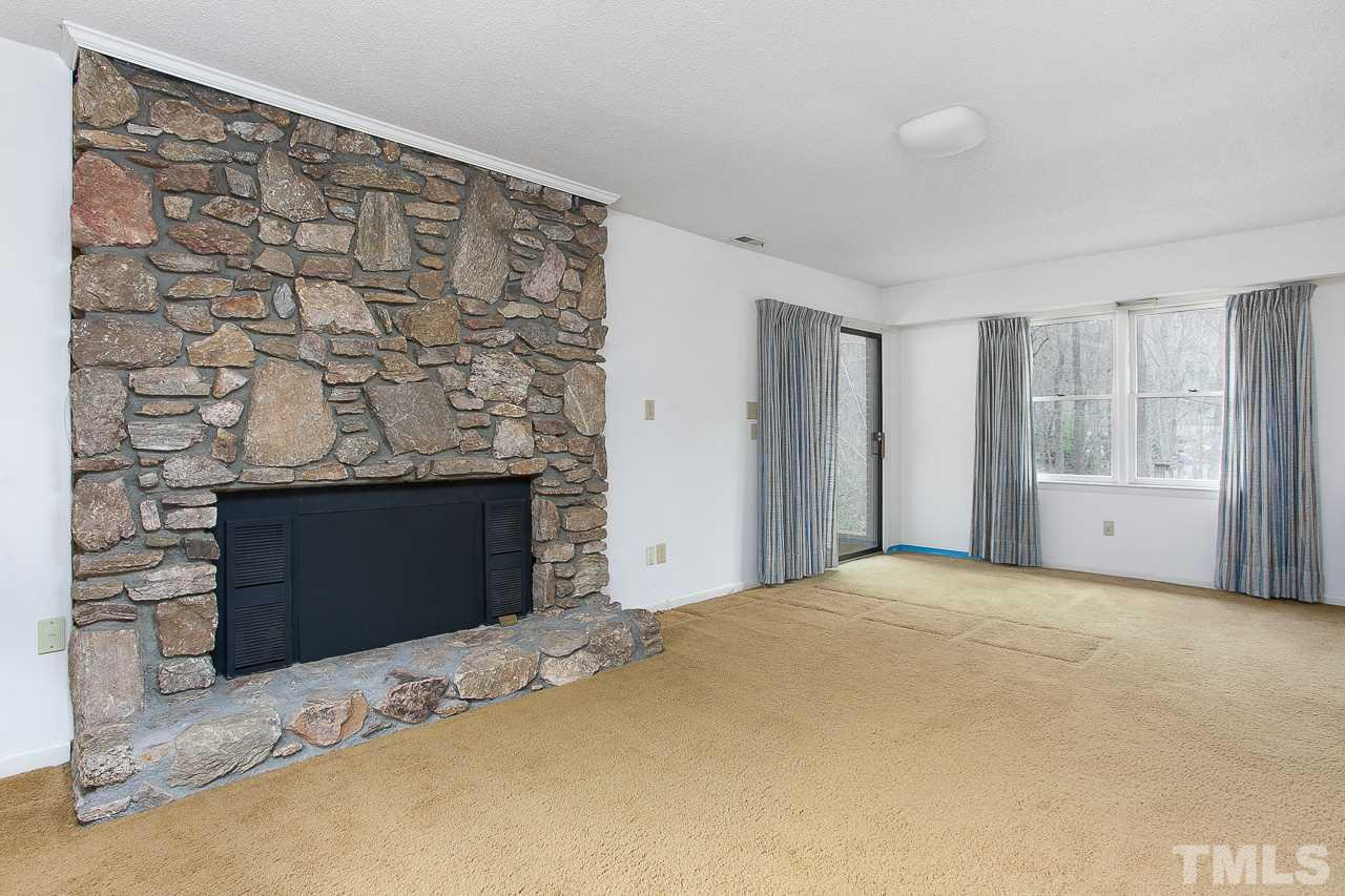 6324 Rushingbrook Drive Raleigh, NC 27612 - Photo 10 of 17 a view of empty room with a fireplace