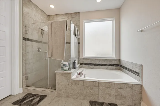 a bathroom with a bathtub and shower