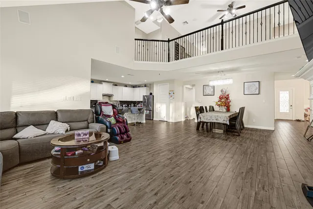 a living room with furniture and a wooden floor