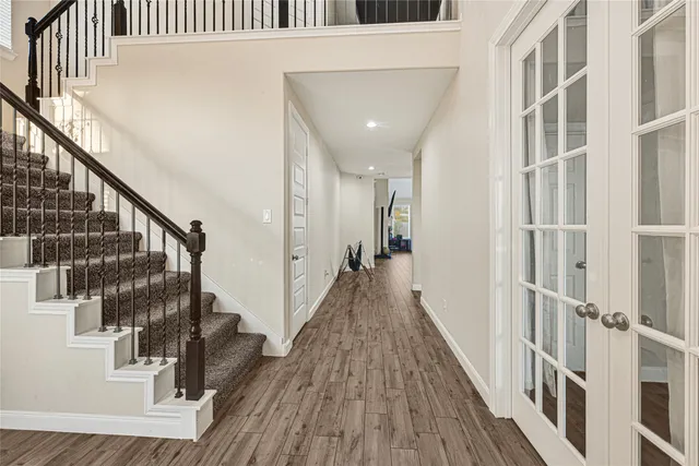 a view of entryway with wooden floor and stairs