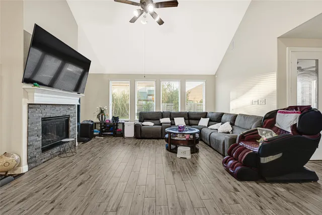 a living room with furniture fireplace and flat screen tv