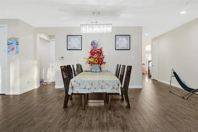 a view of a dining room with furniture and wooden floor