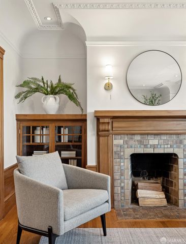 a living room with furniture a fireplace and kitchen view