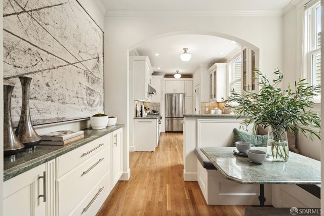 a view of a kitchen with kitchen island a counter top space a sink and cabinets
