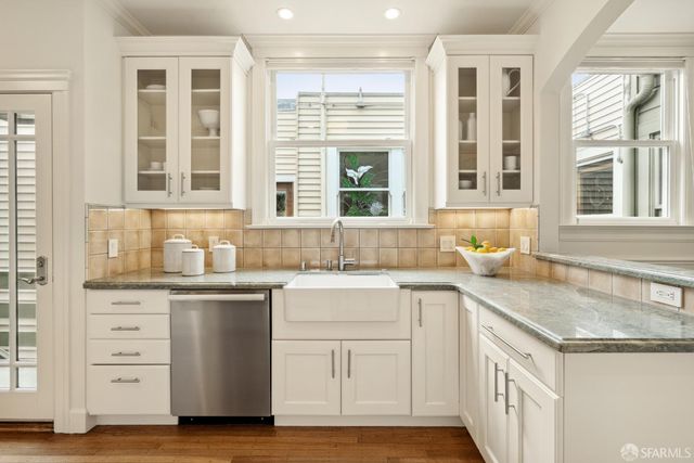 a kitchen with granite countertop a sink and a window