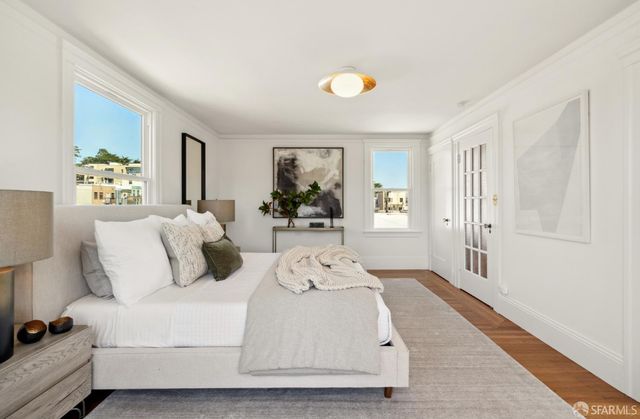 a large white bed in a white room