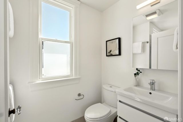 a bathroom with a sink toilet and vanity