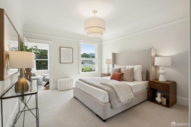 a bedroom with a bed and a chandelier