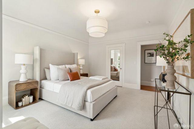 a bedroom with a bed and a chandelier