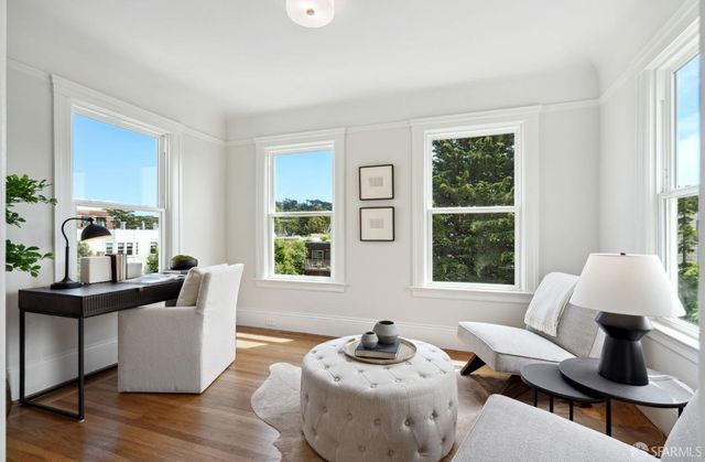 a living room with furniture and two window