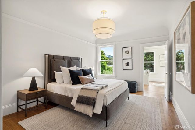 a bedroom with a bed a table and chair