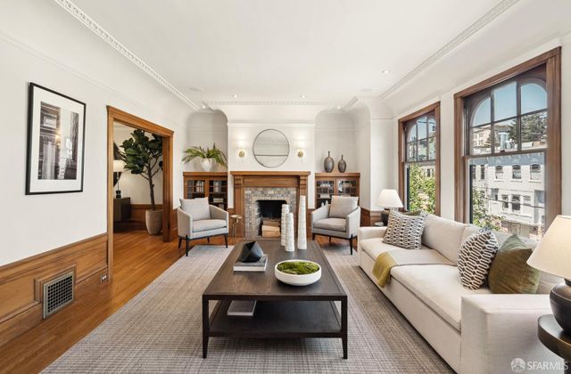 a living room with furniture and a fireplace