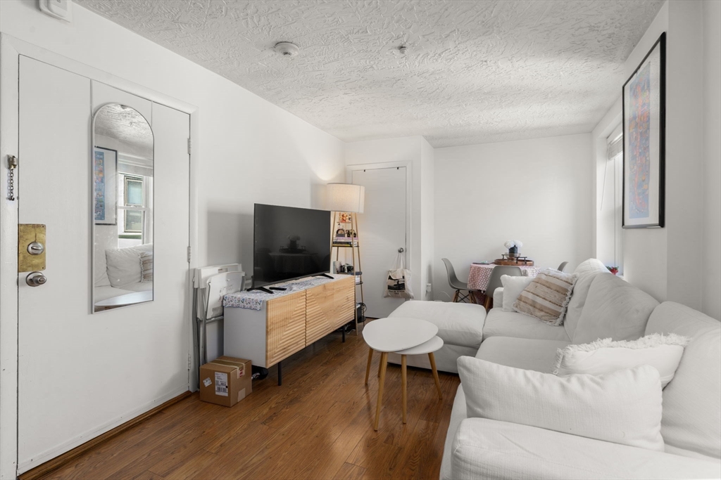 328 Commercial Street, Unit 53 Boston, MA 02109 - Photo 3 of 14 a living room with furniture and a flat screen tv