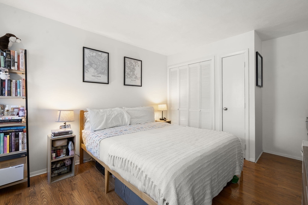 328 Commercial Street, Unit 53 Boston, MA 02109 - Photo 4 of 14 a bedroom with a bed and a book shelf