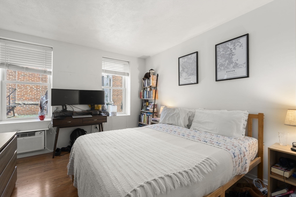 328 Commercial Street, Unit 53 Boston, MA 02109 - Photo 5 of 14 a bedroom with a bed and a flat screen tv