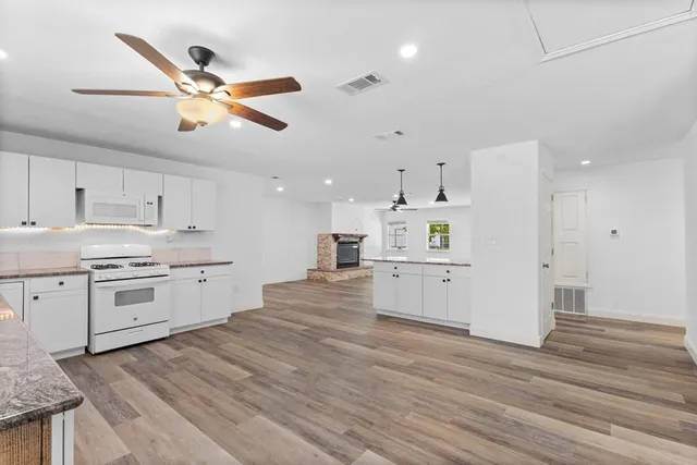 a kitchen with a white cabinets and stainless steel appliances
