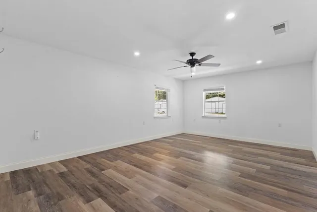 wooden floor in an empty room with a window
