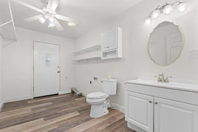 a bathroom with a toilet a sink and a mirror
