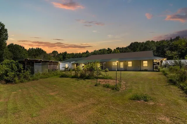 a view of house with a yard