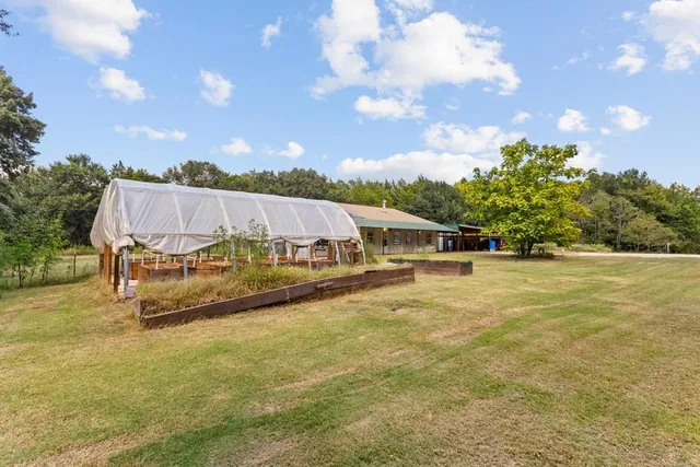 a view of a swimming pool and trees in the background