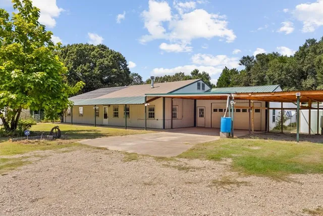 a big house with a big yard and large trees