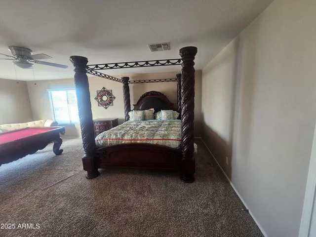 a bedroom with a bed and a mirror