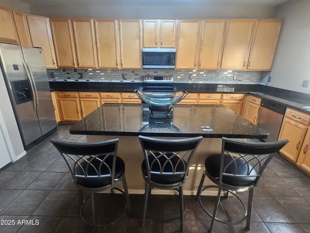 a kitchen with a table chairs and a stove