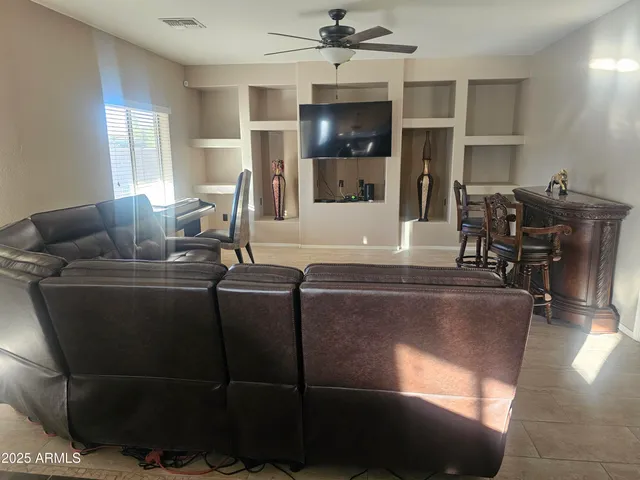 a living room with furniture and flat screen tv