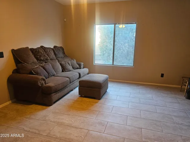 a living room with a couch and a window