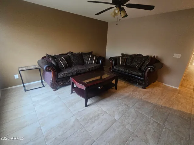 a living room with furniture and a rug