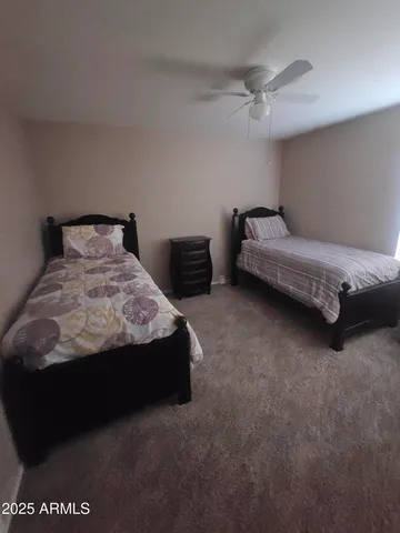 a bedroom with a bed and a night stand