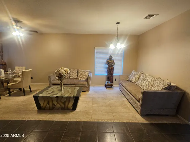 a living room with furniture and a chandelier