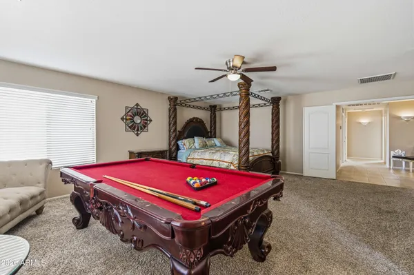 a bedroom with a bed and a chandelier