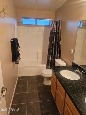 a view of a house with patio and a yard