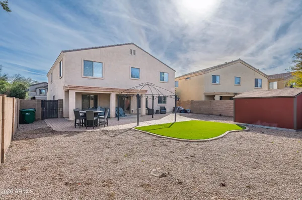 an aerial view of a house with a swimming pool patio and outdoor seating