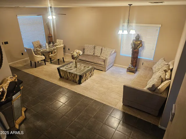 a living room with furniture and chandelier