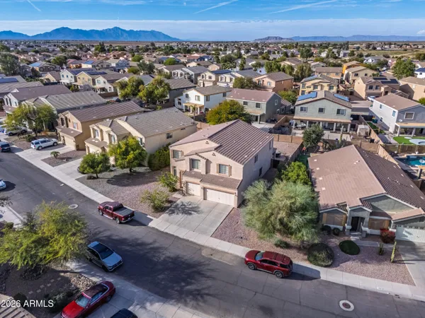a living room with couches a dining table and chairs with wooden floor