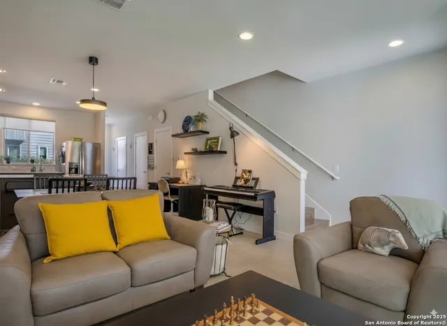 a living room with furniture kitchen view and a table