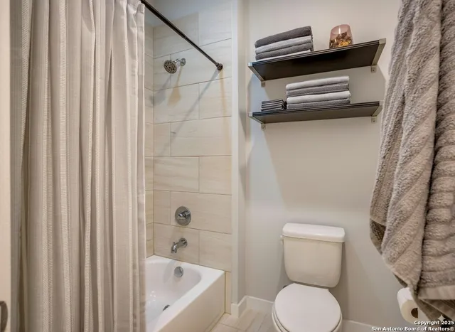 a bathroom with a toilet a sink and bathtub