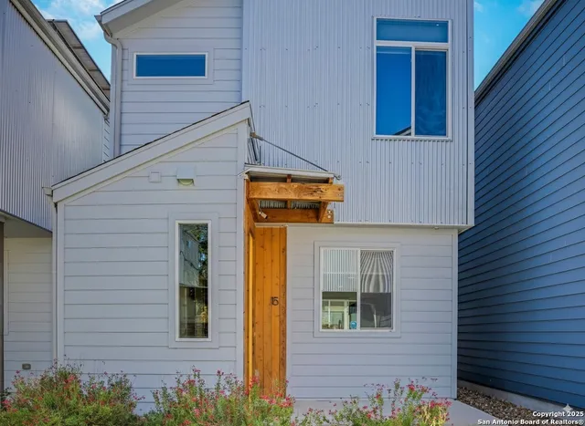 a view of a brick house with potted plants