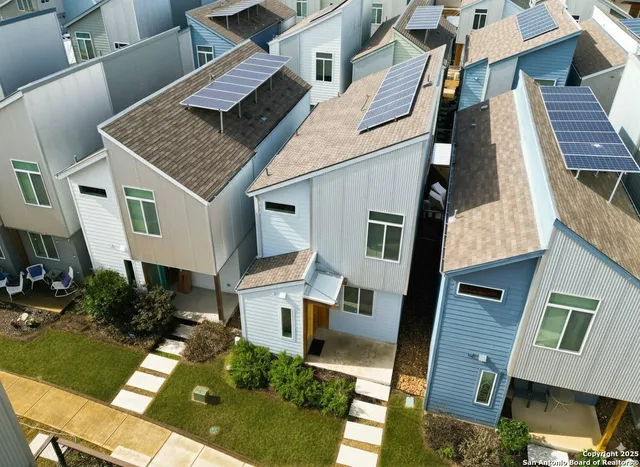 an aerial view of residential houses with outdoor space