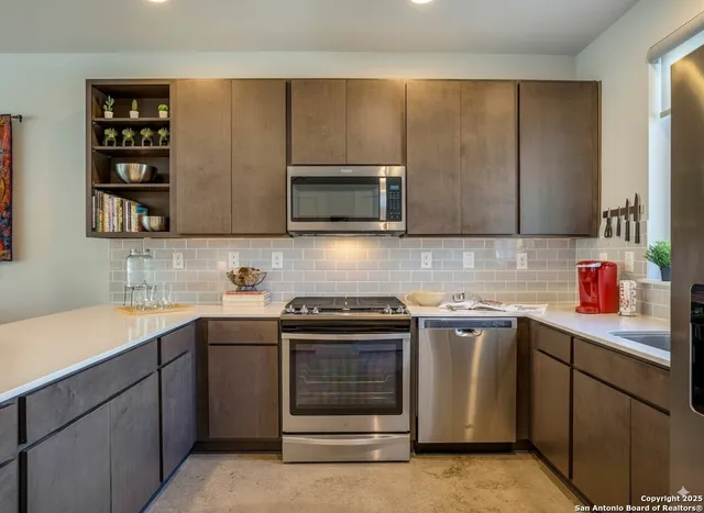 a kitchen with a sink stove and microwave