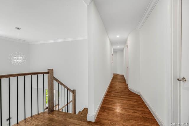 1 Kewanee Road New Rochelle, NY 10804 - Photo 24 of 36 Upper landing featuring wood-finish flooring, a contemporary chandelier, and a hallway with recessed lighting