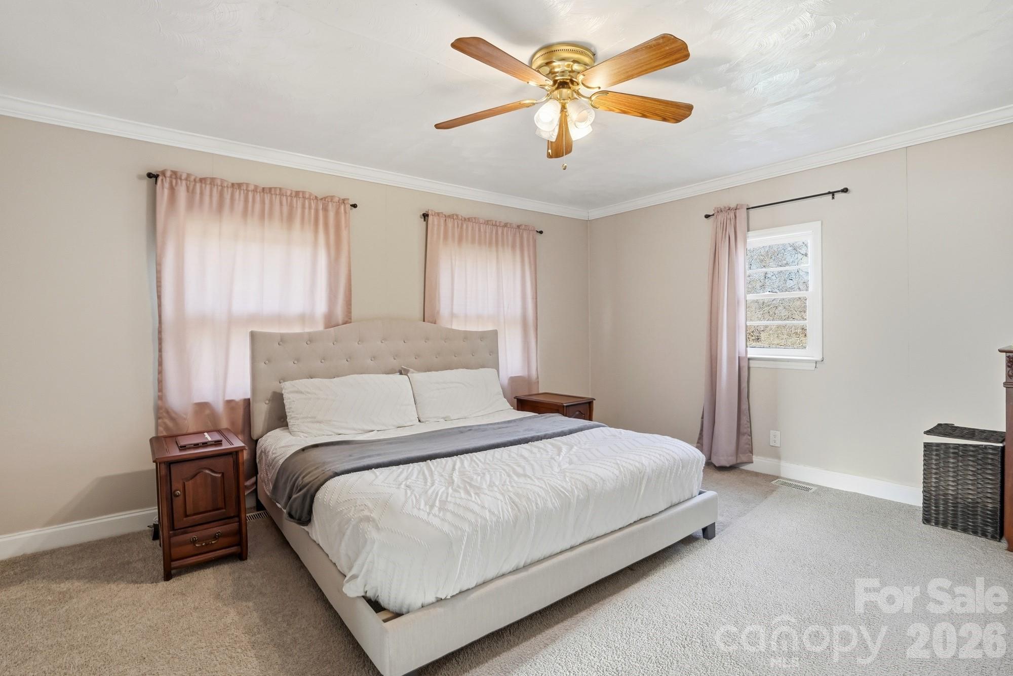 211 Ratchford Farm Road Gastonia, NC 28056 - Photo 12 of 24 a bedroom with a large bed and a chandelier