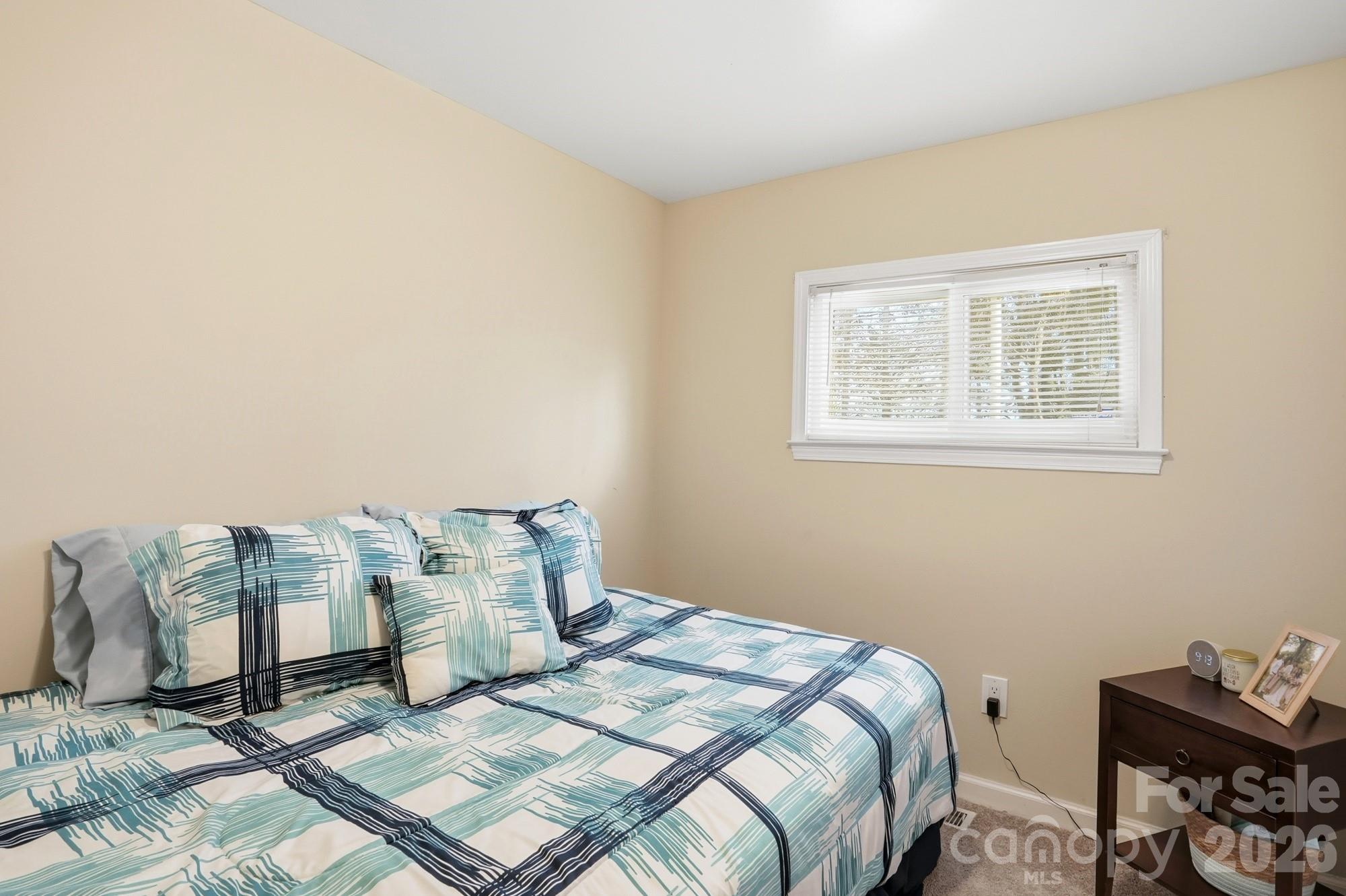 211 Ratchford Farm Road Gastonia, NC 28056 - Photo 16 of 24 a bed sitting in a bedroom next to a window