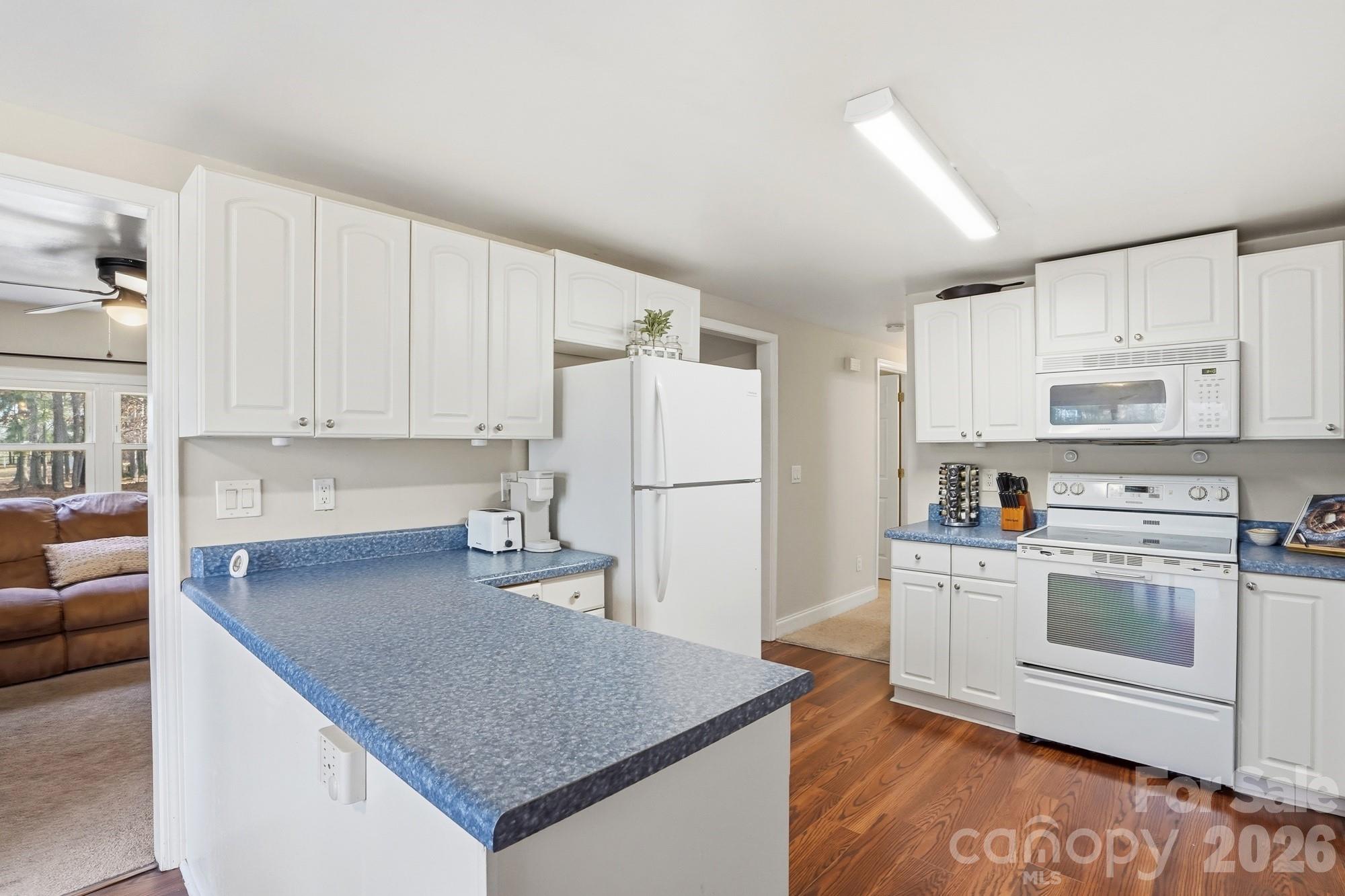 211 Ratchford Farm Road Gastonia, NC 28056 - Photo 7 of 24 a kitchen with cabinets and wooden floor