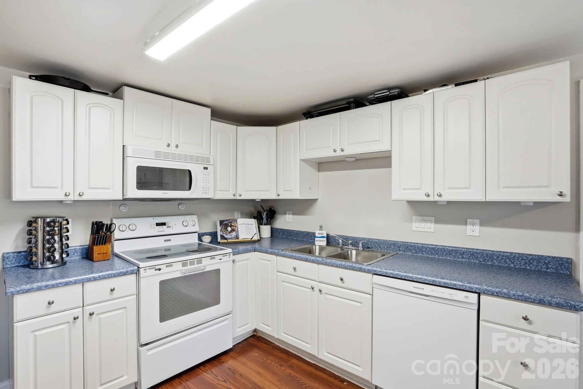 211 Ratchford Farm Road Gastonia, NC 28056 - Photo 8 of 24 a kitchen with cabinets appliances a sink and a counter space