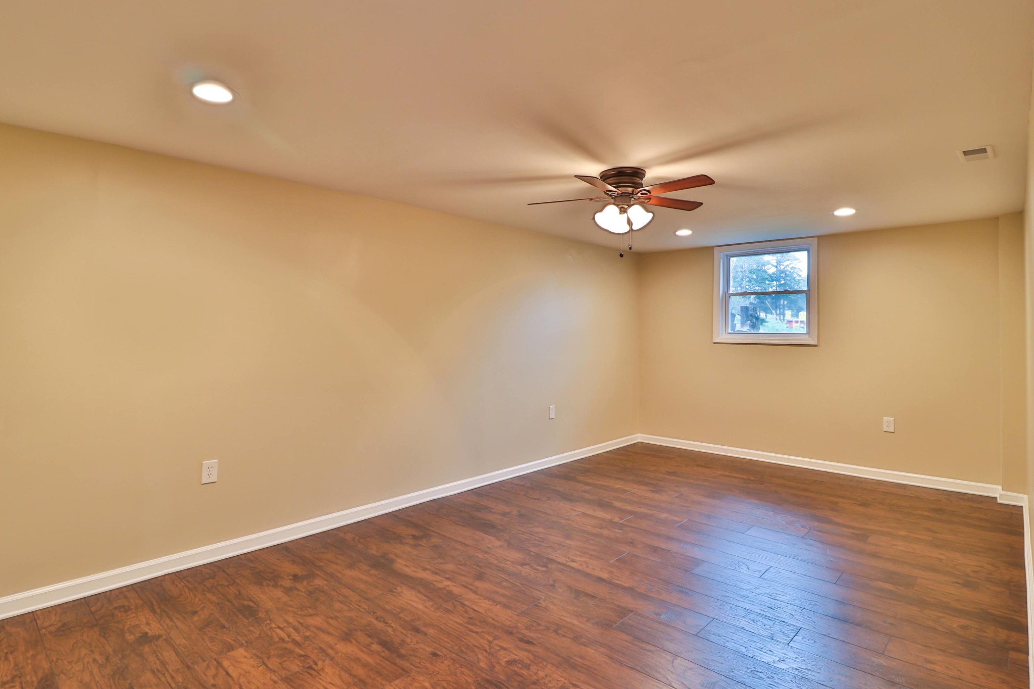 2212 Roundtree Road Knoxville, TN 37923 - Photo 16 of 27 a view of an empty room with a ceiling fan and wooden floor