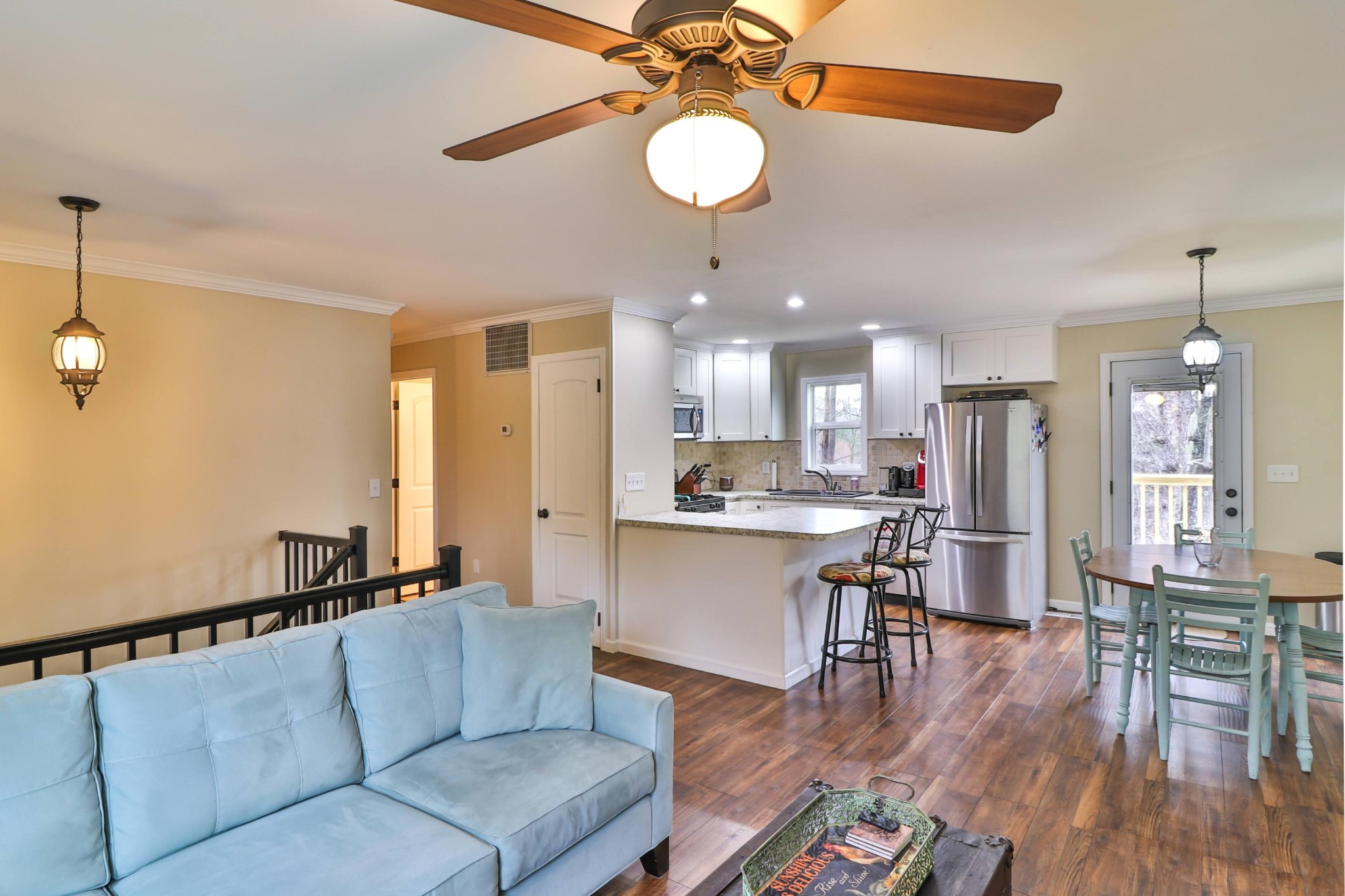 2212 Roundtree Road Knoxville, TN 37923 - Photo 5 of 27 a living room with kitchen island furniture and a chandelier fan
