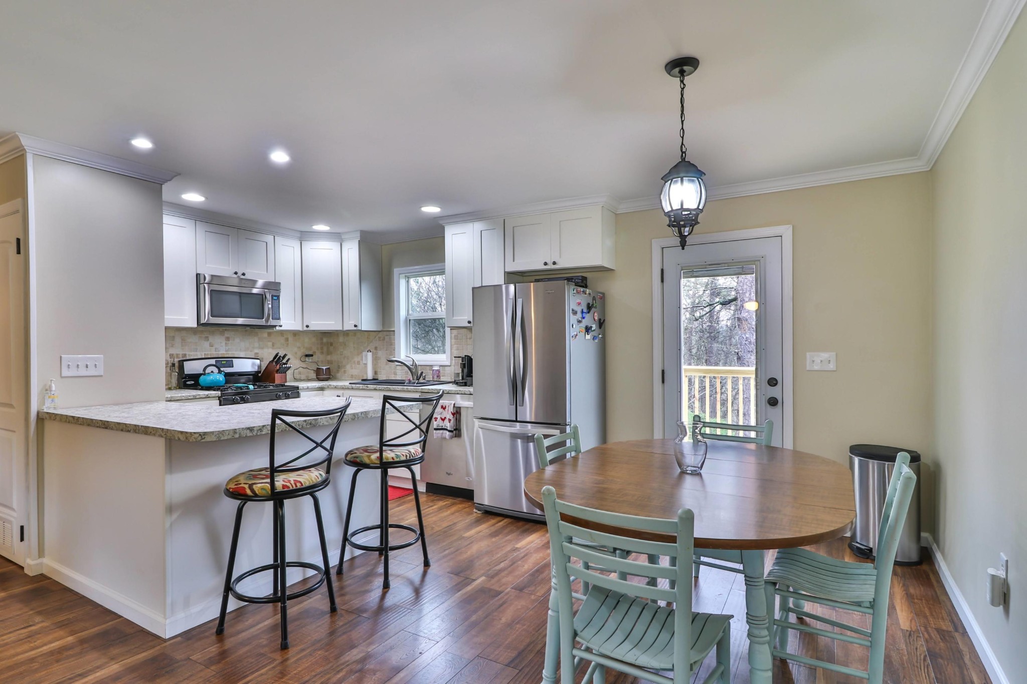 2212 Roundtree Road Knoxville, TN 37923 - Photo 6 of 27 a kitchen with stainless steel appliances granite countertop a dining table chairs refrigerator and sink